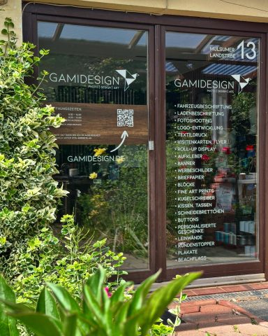 Schaufenster eines Designgeschäfte mit Pflanzen und verschiedenen Beschriftungen.